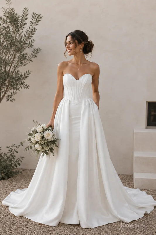 Ivory satin mermaid wedding dress with a strapless sweetheart corset bodice and dramatic open-front overskirt.