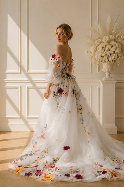 Off-the-shoulder ball gown with colorful floral embroidery, sheer puff sleeves, and a flowing chapel-length train.