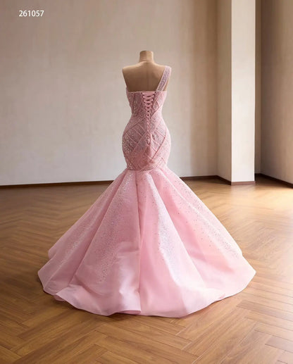 Pink one-shoulder mermaid quinceañera dress with a sparkling crisscross lattice bodice and lace-up back.