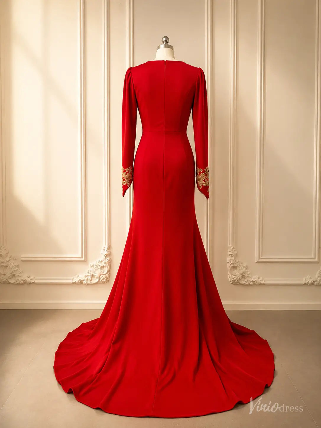 Back view of a red long sleeve evening gown with gold beaded lace cuffs and a sweeping train.