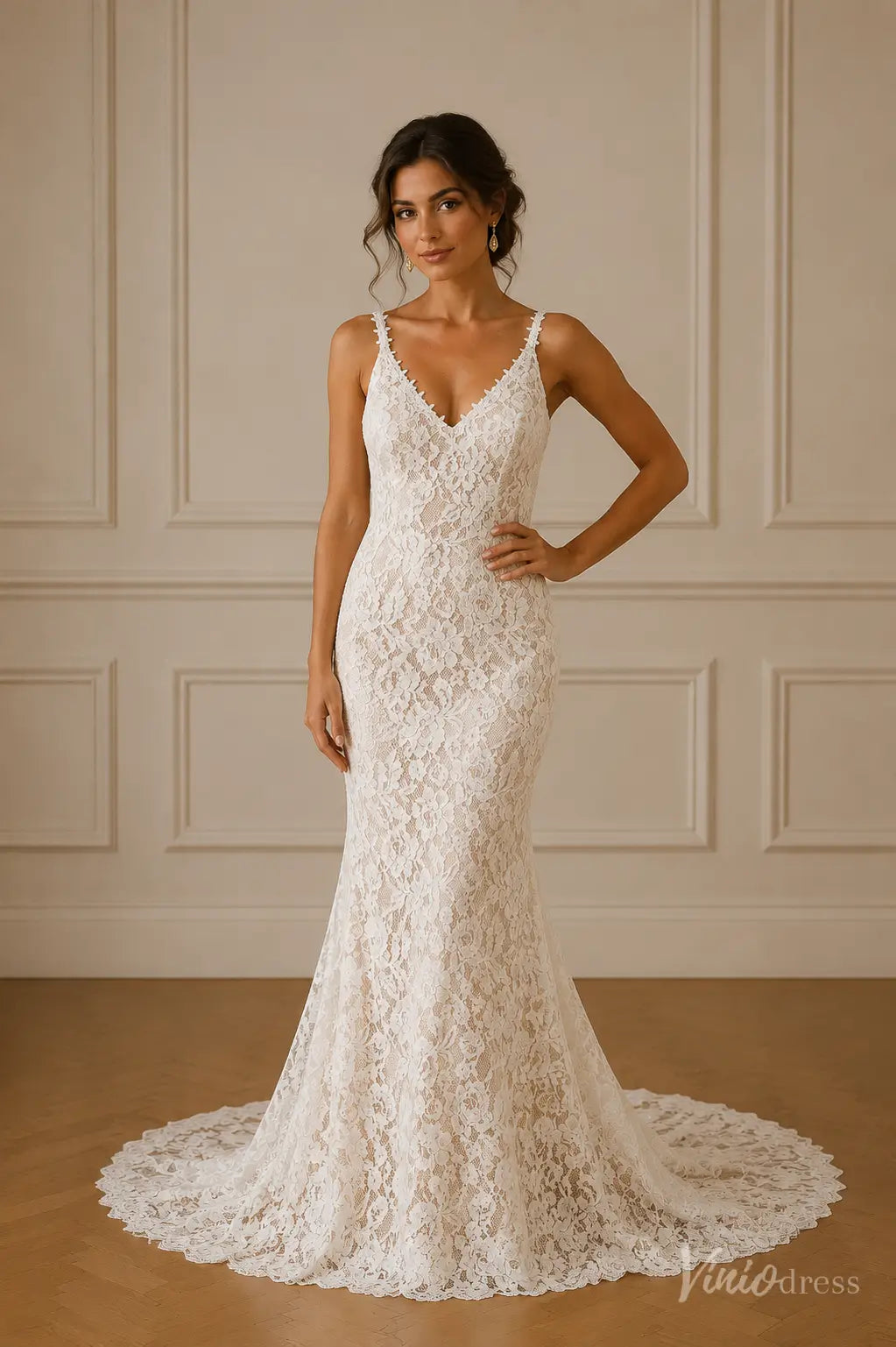 Boho mermaid wedding dress in white floral lace with a V-neck, delicate straps, and a scalloped lace train.