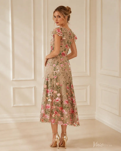 Midi length V-neck evening dress in beige with colorful floral embroidery, cap sleeves, and a flattering A-line silhouette.