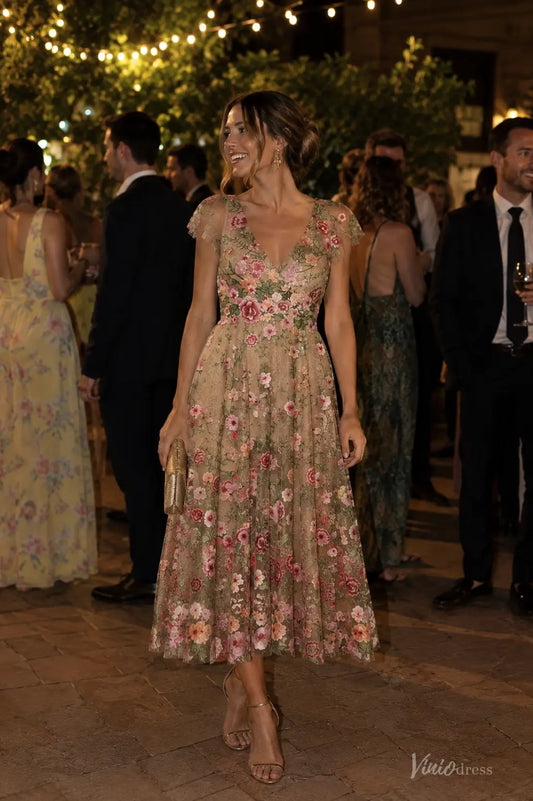 Midi length V-neck evening dress in beige tulle with colorful floral embroidery and delicate cap sleeves for weddings.