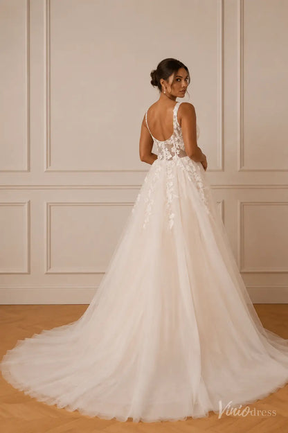 A-line wedding dress with a sheer lace bodice, scoop back, and flowing tulle skirt in ivory.