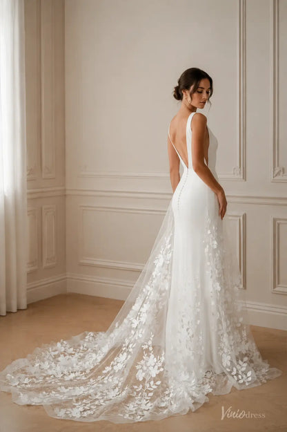 White ML192 wedding dress with a deep back, button details, and a sheer floral lace train in a minimalist room.
