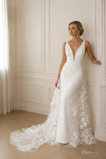 ML192 white V-neck wedding dress with a sleek bodice and a sheer floral appliqué train.