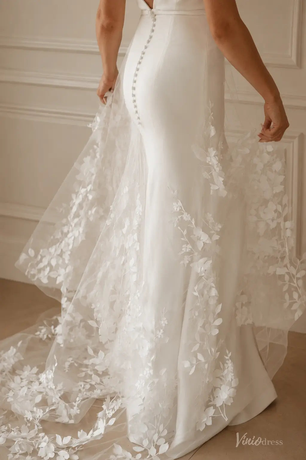 White ML192 wedding dress with a fitted silhouette, button-up back, and sheer floral lace train.