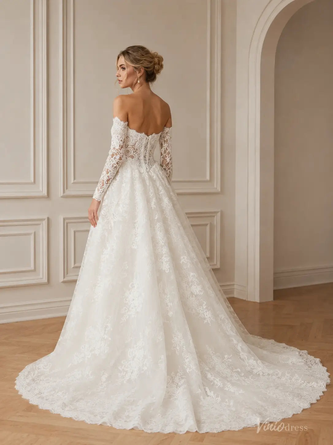 Off-the-shoulder white lace wedding dress with long sleeves and a full A-line skirt with a train.