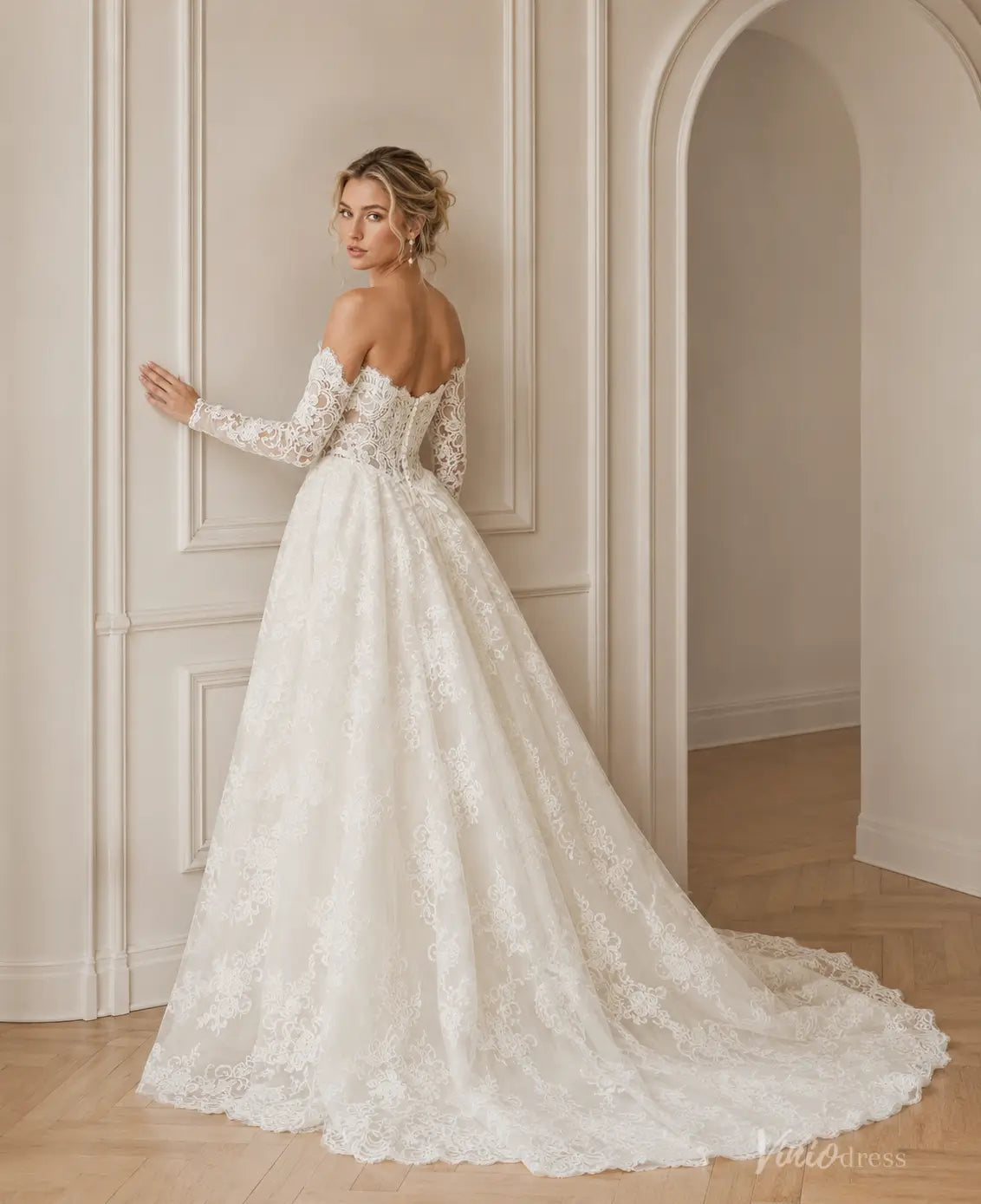 Off-the-shoulder LC123 wedding dress featuring intricate white lace, long sleeves, and a full, flowing floor-length skirt.