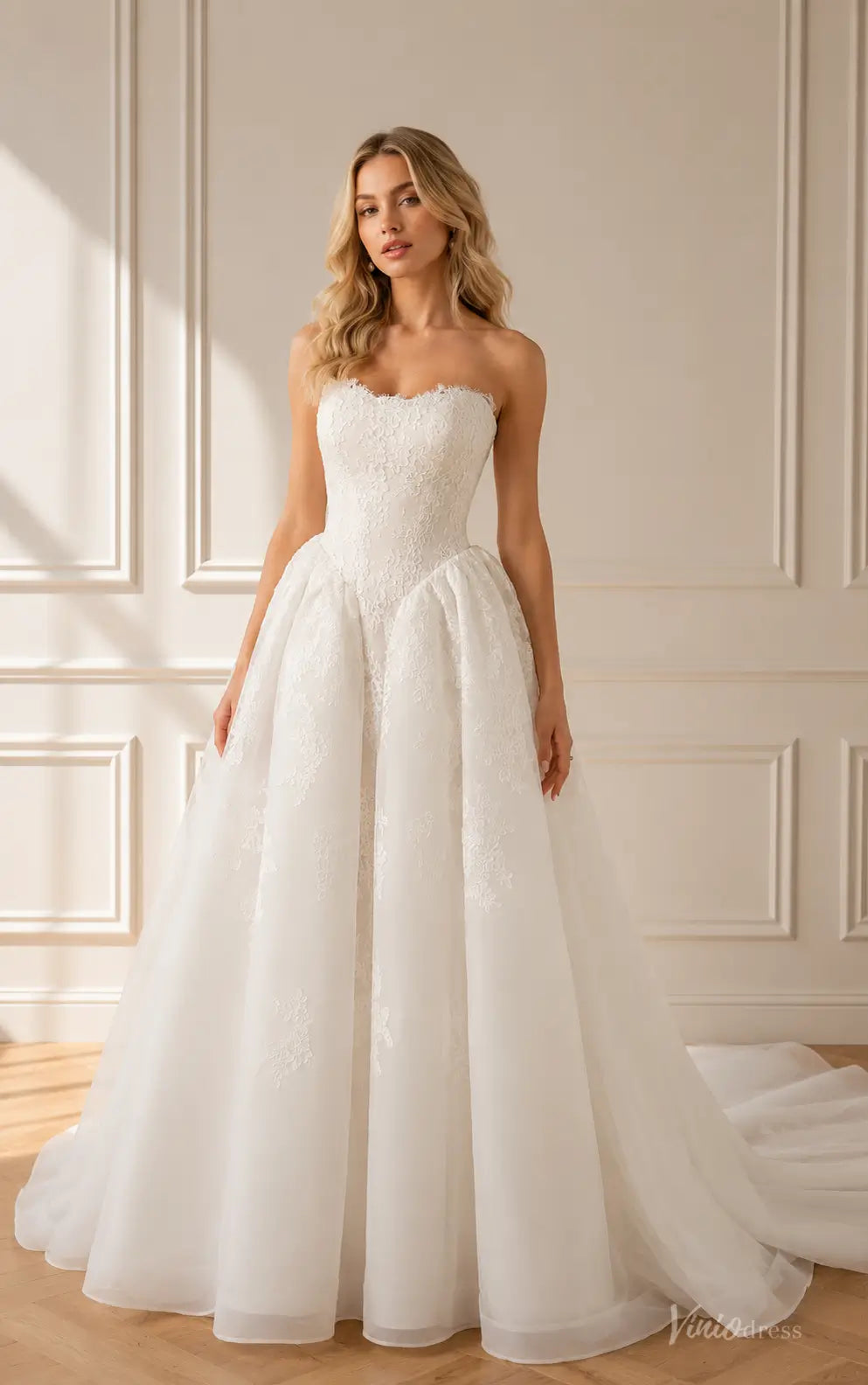 Strapless white A-line wedding dress with a lace bodice, sweetheart neckline, and a full, layered tulle skirt.