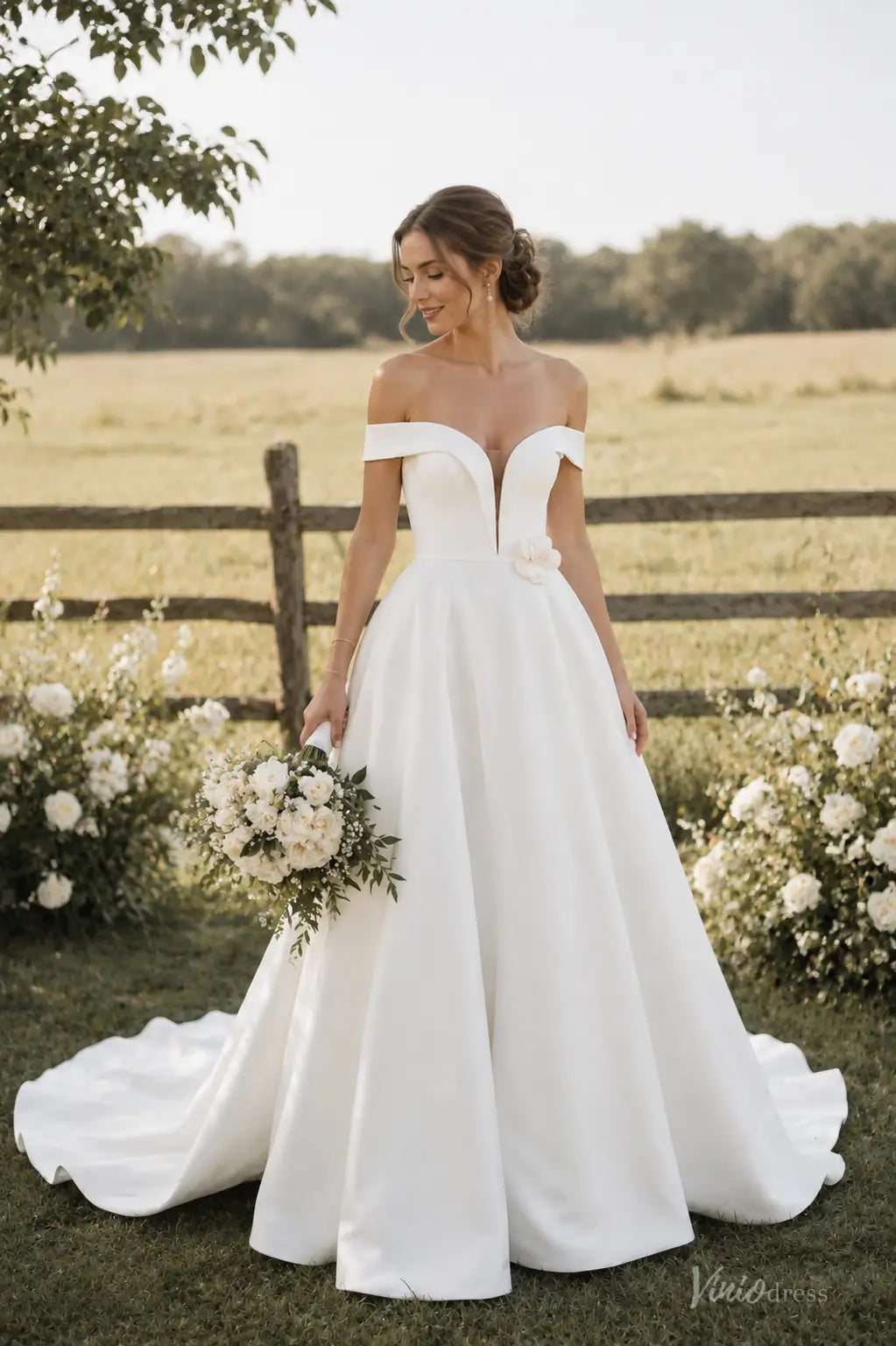 Ivory satin A-line wedding dress with off-shoulder sleeves, plunging V-neckline, and 3D floral waist detail.