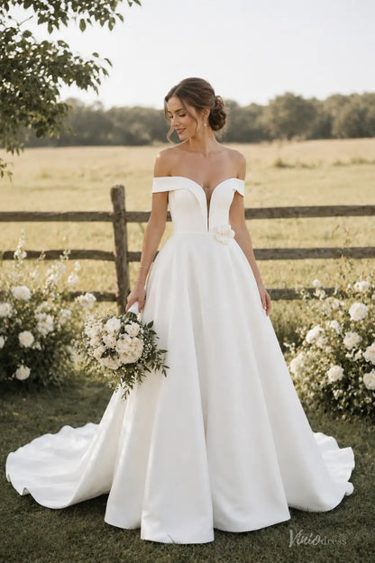 Ivory satin A-line wedding dress with off-shoulder sleeves, plunging V-neckline, and 3D floral waist detail.