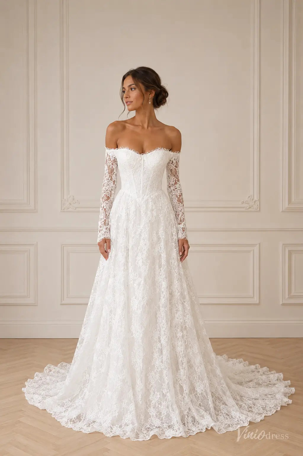 Off-the-shoulder white lace wedding dress with long sleeves, a sweetheart corset bodice, and a flowing A-line skirt.