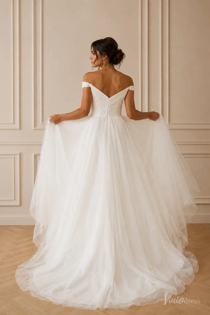 Off-the-shoulder white wedding dress with a fitted bodice and a flowing, layered tulle A-line skirt.