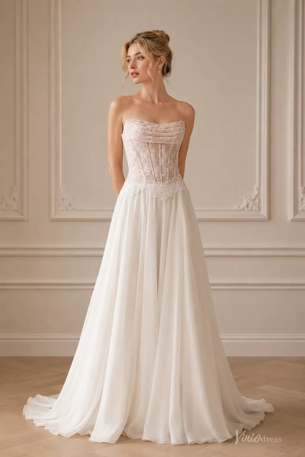 Strapless white beach wedding dress with a sheer lace corset bodice and a flowing A-line chiffon skirt.