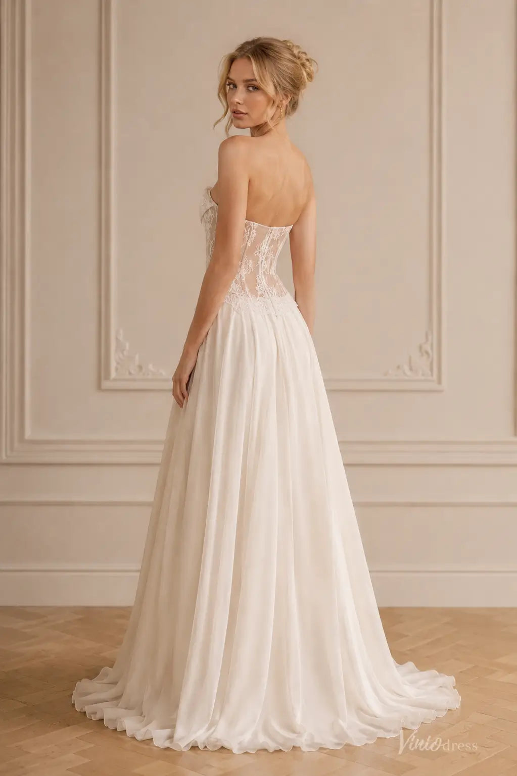 Strapless ivory beach wedding dress with a sheer lace corset bodice and a flowing A-line chiffon skirt.
