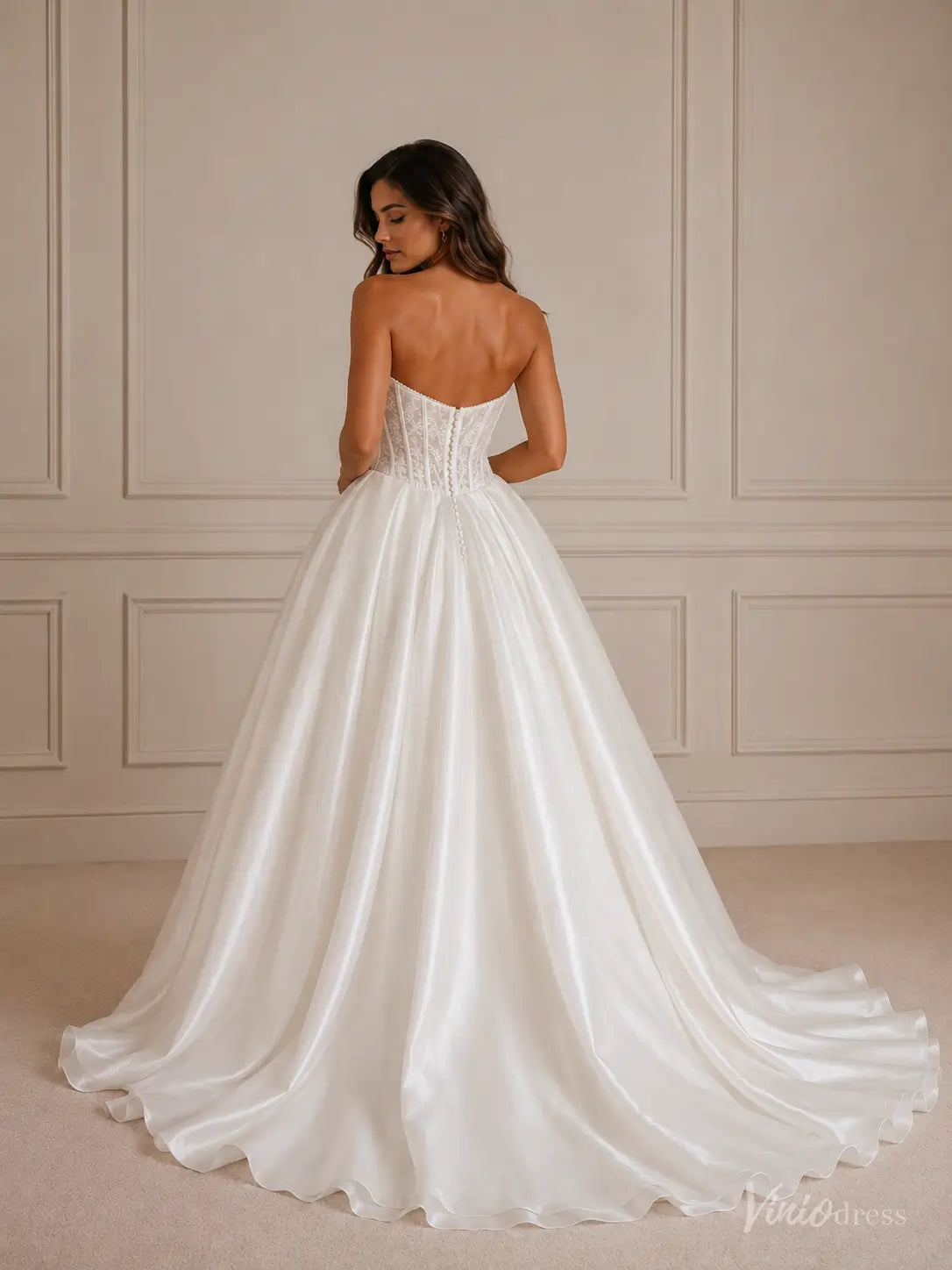 Strapless white ball gown wedding dress with a lace corset bodice and a full satin skirt with a train.