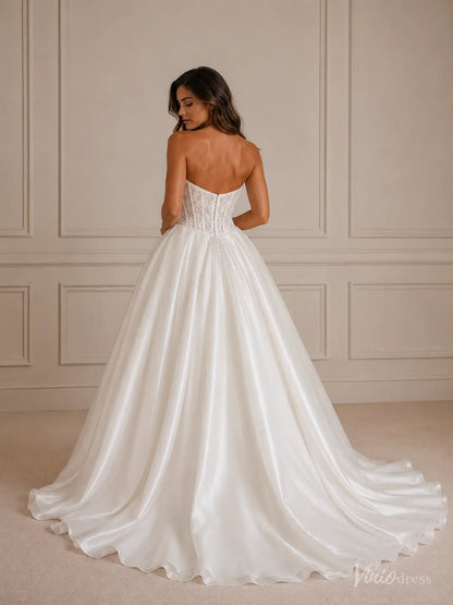 Strapless white ball gown wedding dress with a lace corset bodice and a full satin skirt with a train.