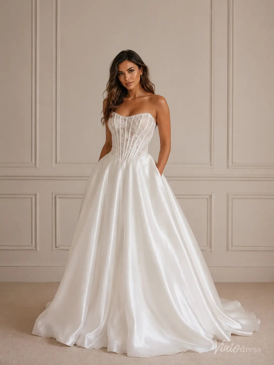 MS173 strapless ivory satin ball gown wedding dress with a sheer lace corset bodice and side pockets.