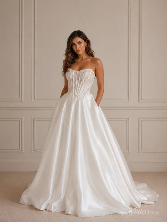 MS173 strapless ivory satin ball gown wedding dress with a sheer lace corset bodice and side pockets.