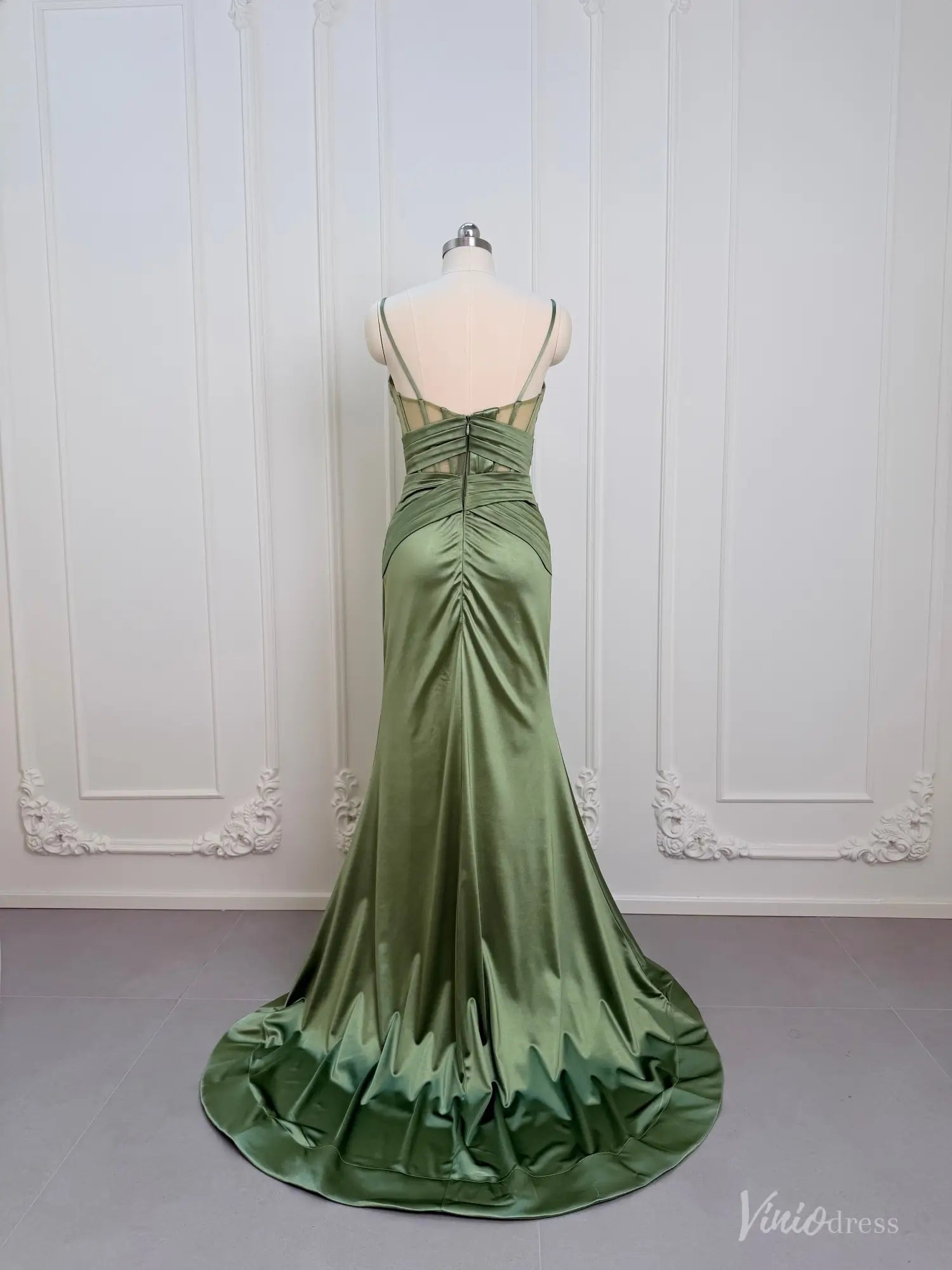 Sage green satin mermaid prom dress with a corset-style open back, ruched waist, and floor-length skirt with a train.