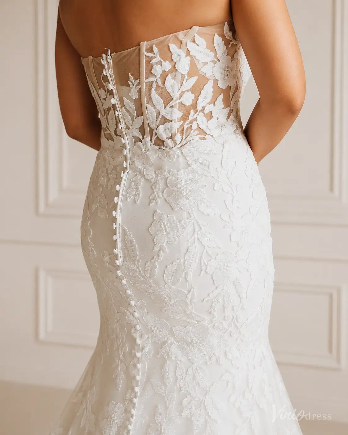 ML201 strapless white wedding dress with floral lace embroidery, sheer corset bodice, and a row of elegant back buttons.