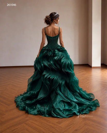 Emerald green quinceañera ball gown with a diamond-beaded corset, basque waist, and voluminous sculptural wave ruffle skirt.