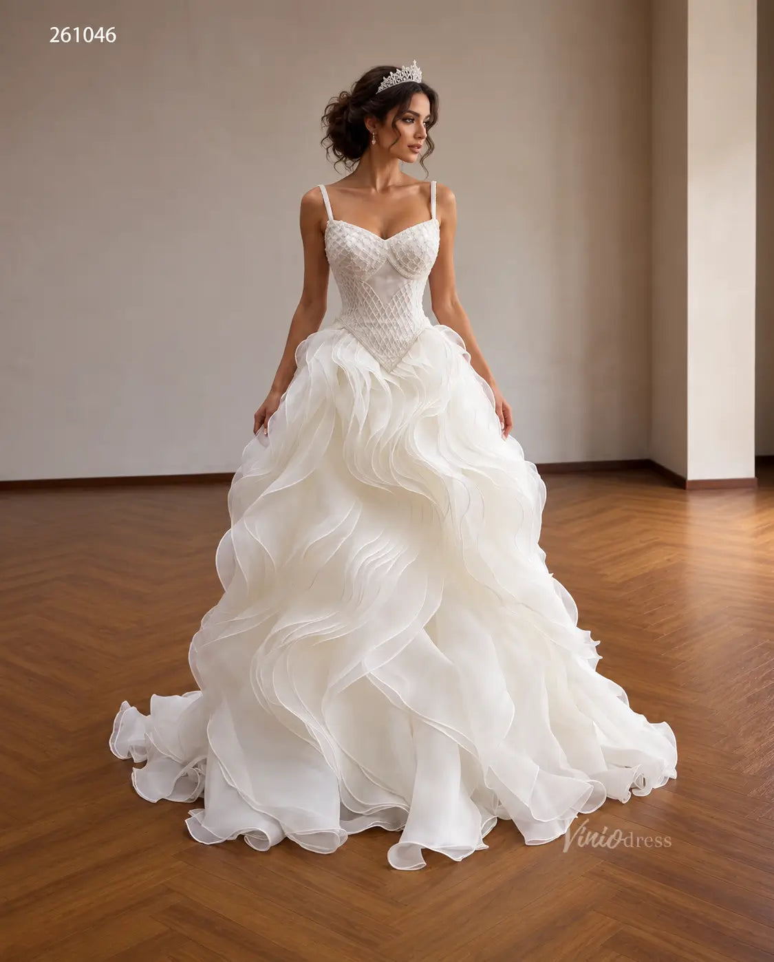 Ivory quinceañera ball gown with a diamond-beaded basque corset, sweetheart neckline, and voluminous sculptural wave ruffles.