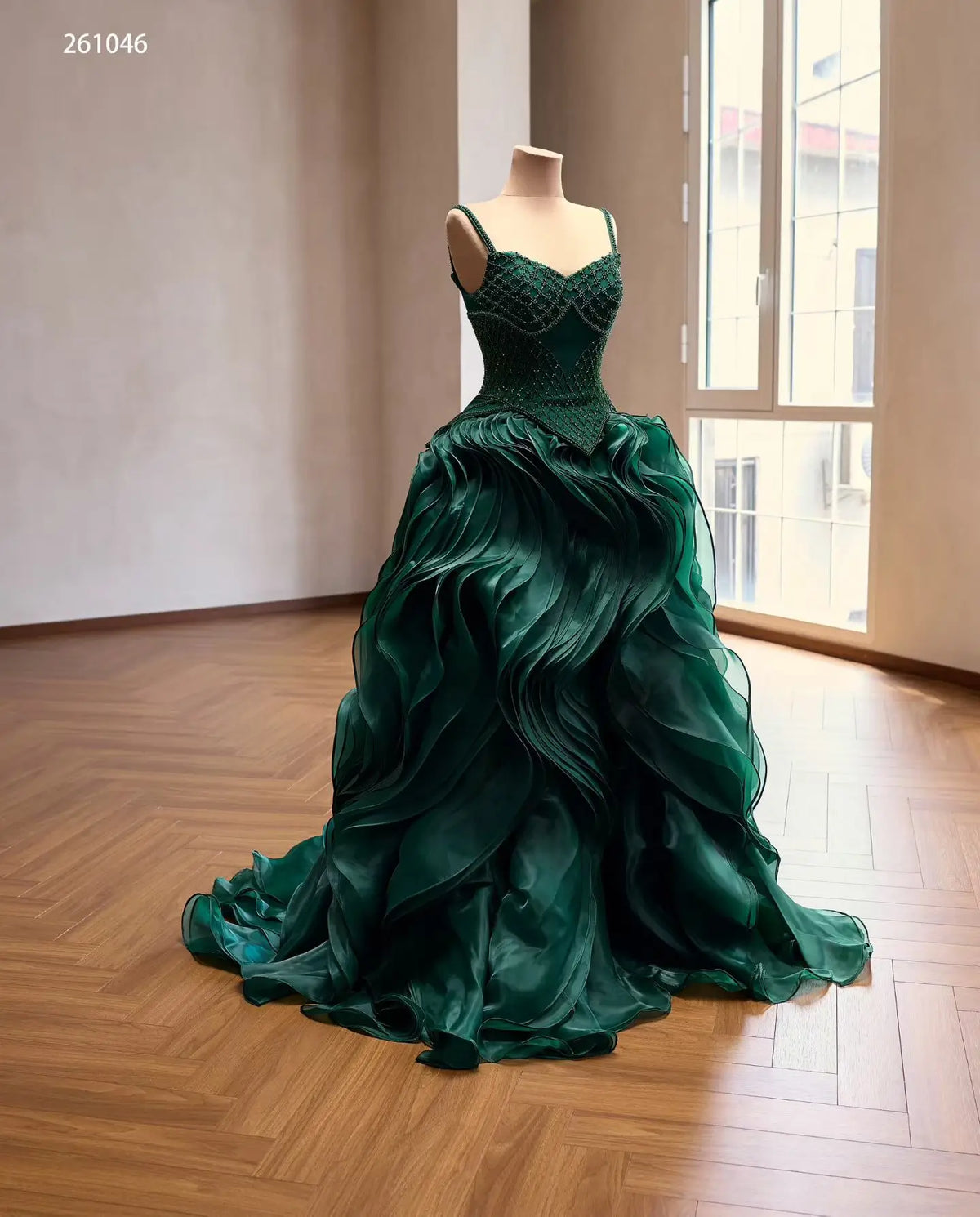 Emerald green ball gown with a diamond-beaded corset, basque waist, and voluminous sculptural wave ruffle skirt.