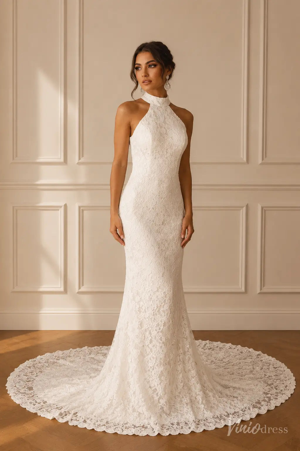 White lace mermaid wedding dress with a high halter neckline and a long, elegant circular train.