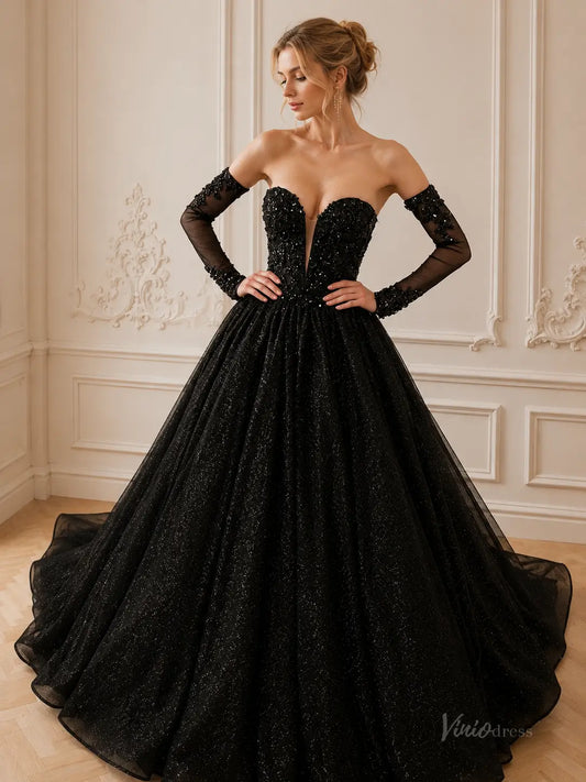 Black strapless ball gown with a plunging neckline, glitter tulle skirt, and matching sheer beaded long sleeves.