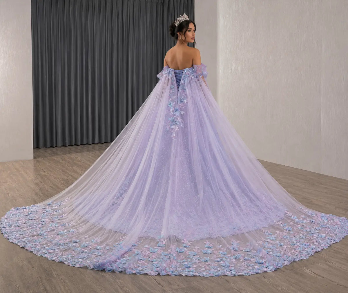 Off-shoulder purple quinceañera ball gown with butterfly appliqués, glitter tulle, and a dramatic long train.