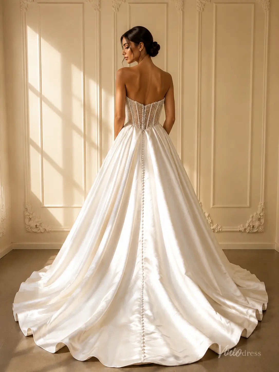 White strapless satin ball gown wedding dress with pearl beaded corset and chapel train with back buttons.