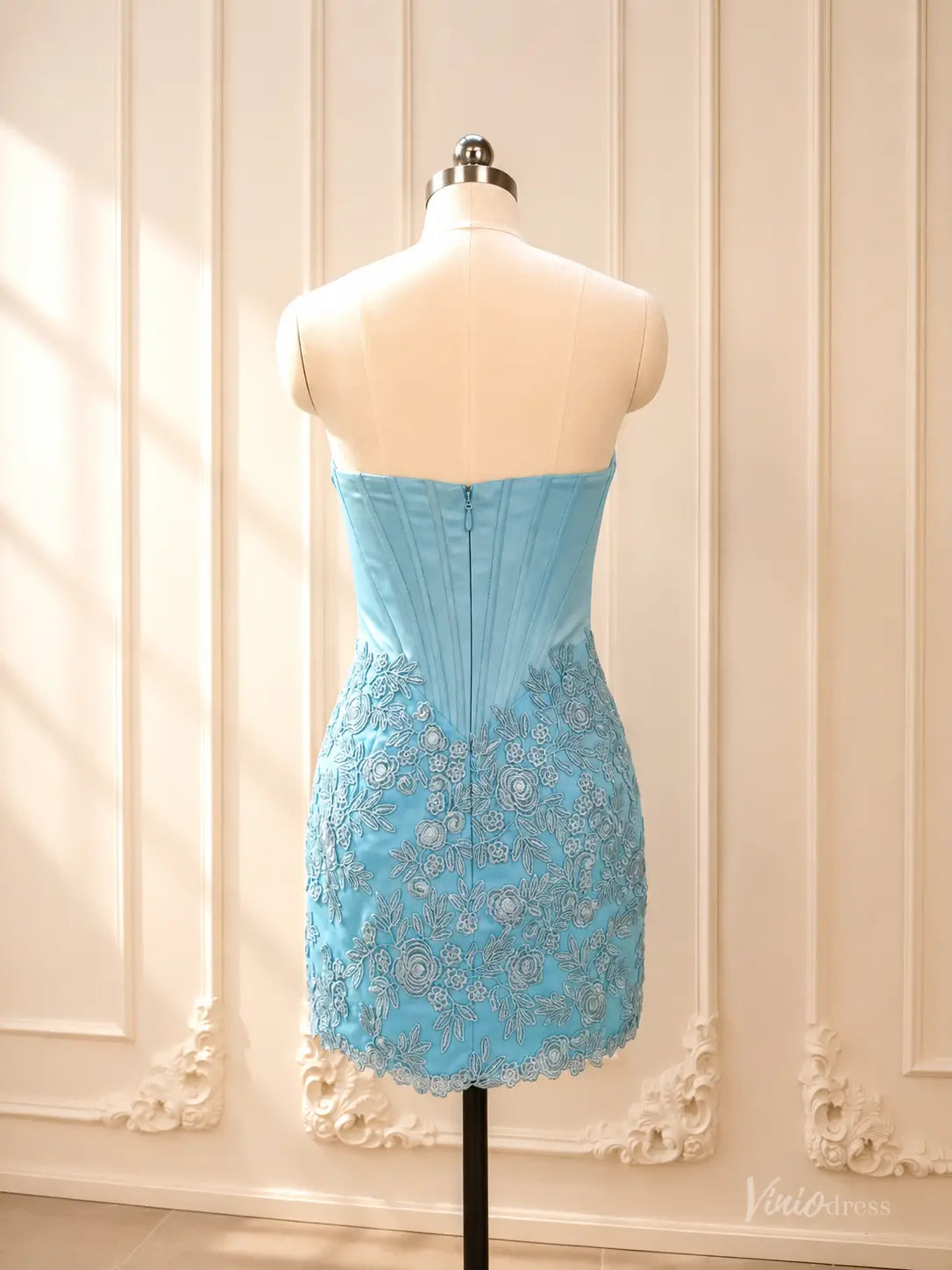 Back of a blue strapless satin corset homecoming dress with lace overlay mini skirt and zipper closure.