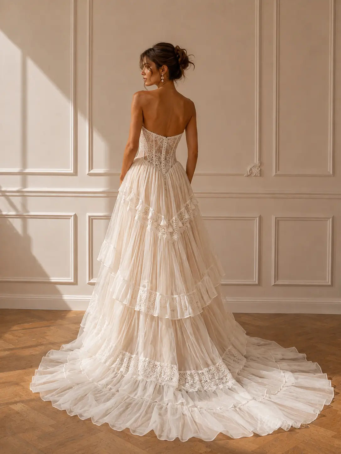 Strapless ivory wedding dress with a lace corset bodice and a tiered tulle skirt featuring intricate lace trim.