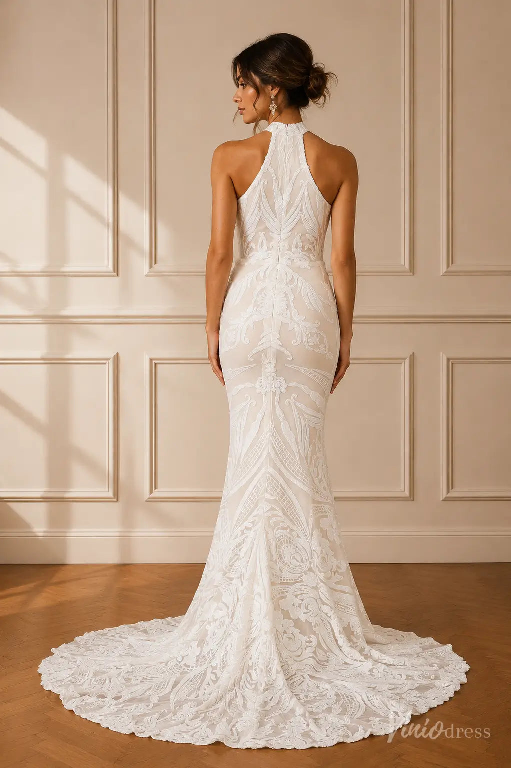 Back view of a white lace mermaid wedding dress with a high halter neckline and a sweeping train.