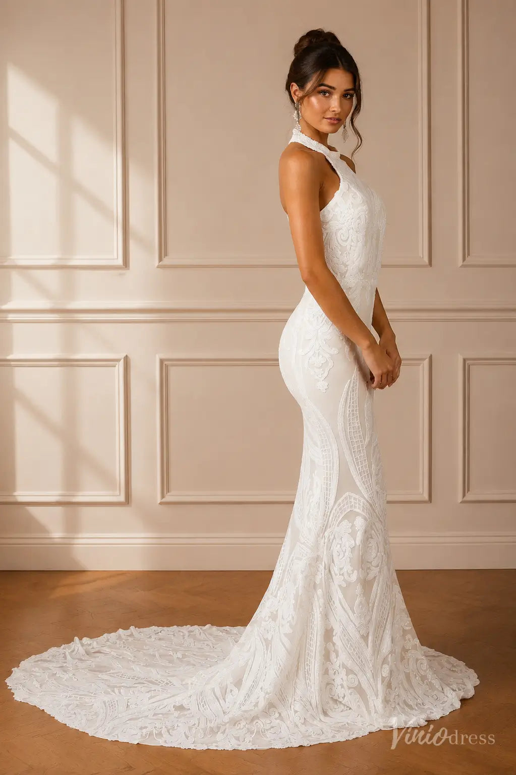 White mermaid wedding dress with intricate lace embroidery, high halter neckline, and a sweeping floor-length train.