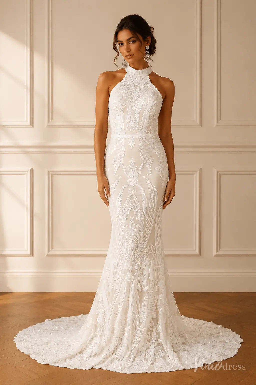 White halter-neck mermaid wedding dress featuring intricate lace embroidery and a flowing floor-length train.