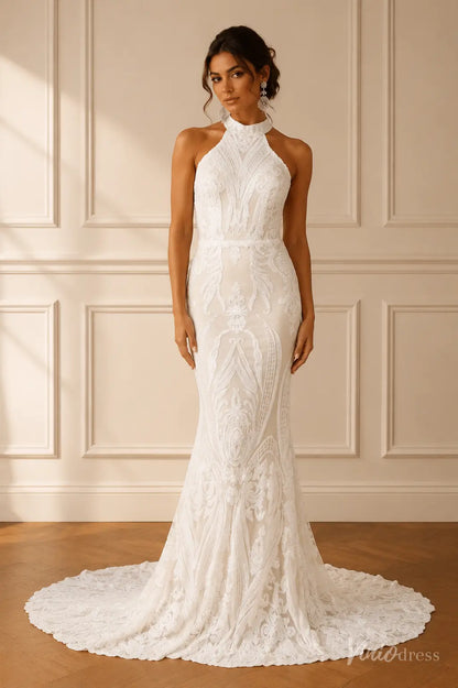 White halter-neck mermaid wedding dress featuring intricate lace embroidery and a flowing floor-length train.