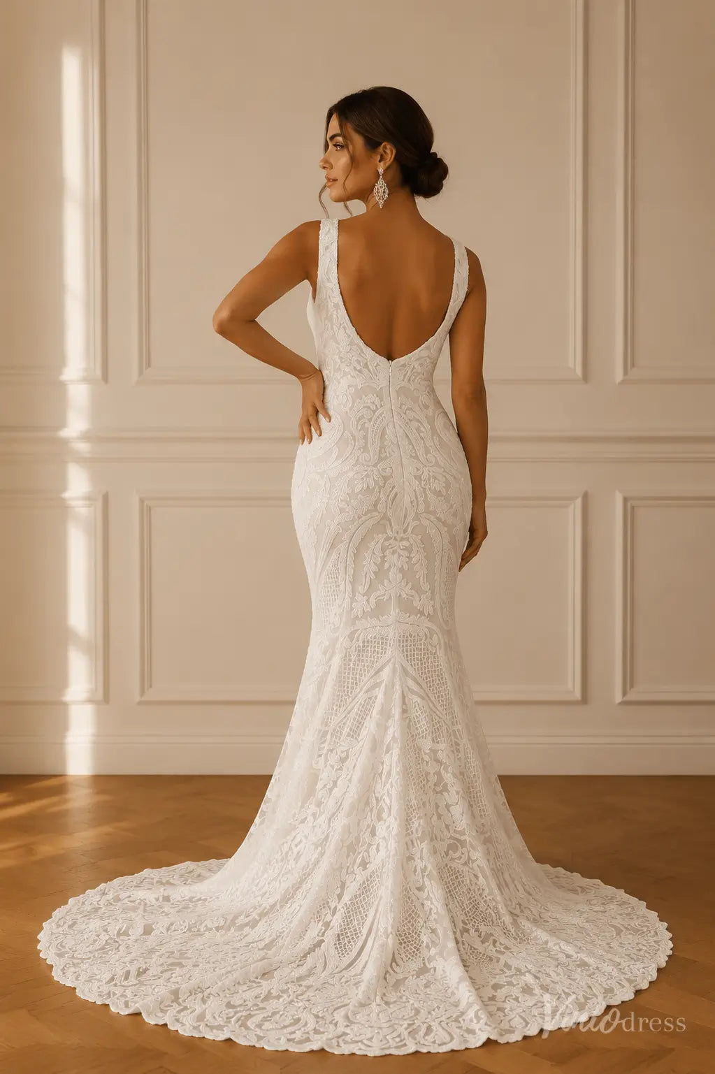 White mermaid wedding dress featuring ornate paisley lace, wide straps, a plunging low back, and a scalloped lace train.