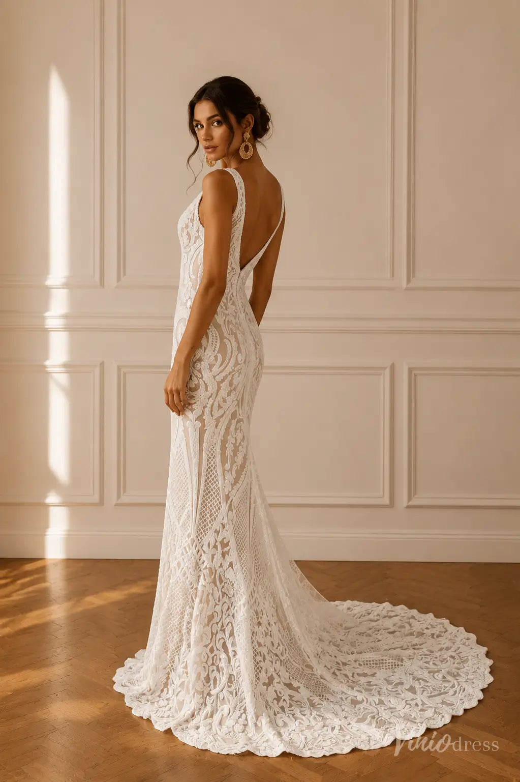 Mermaid wedding dress in white paisley lace with a V-neckline, wide straps, and a dramatic plunging low back.
