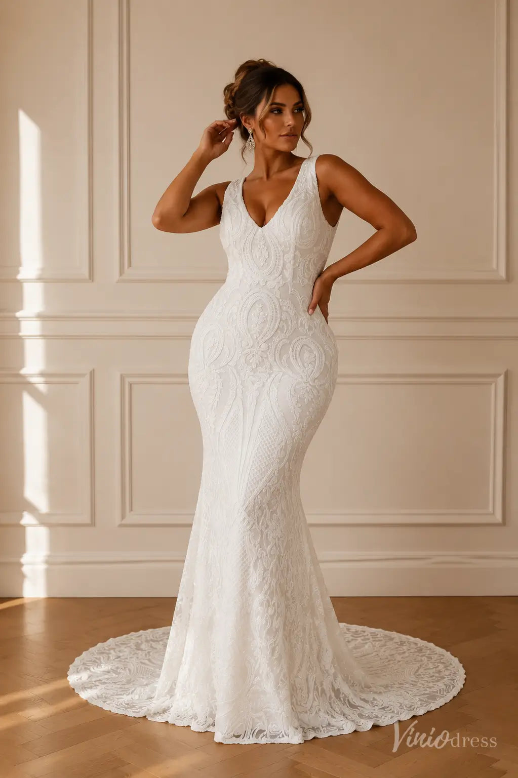 White mermaid wedding dress with ornate paisley lace, V-neckline, wide straps, and a scalloped lace train.