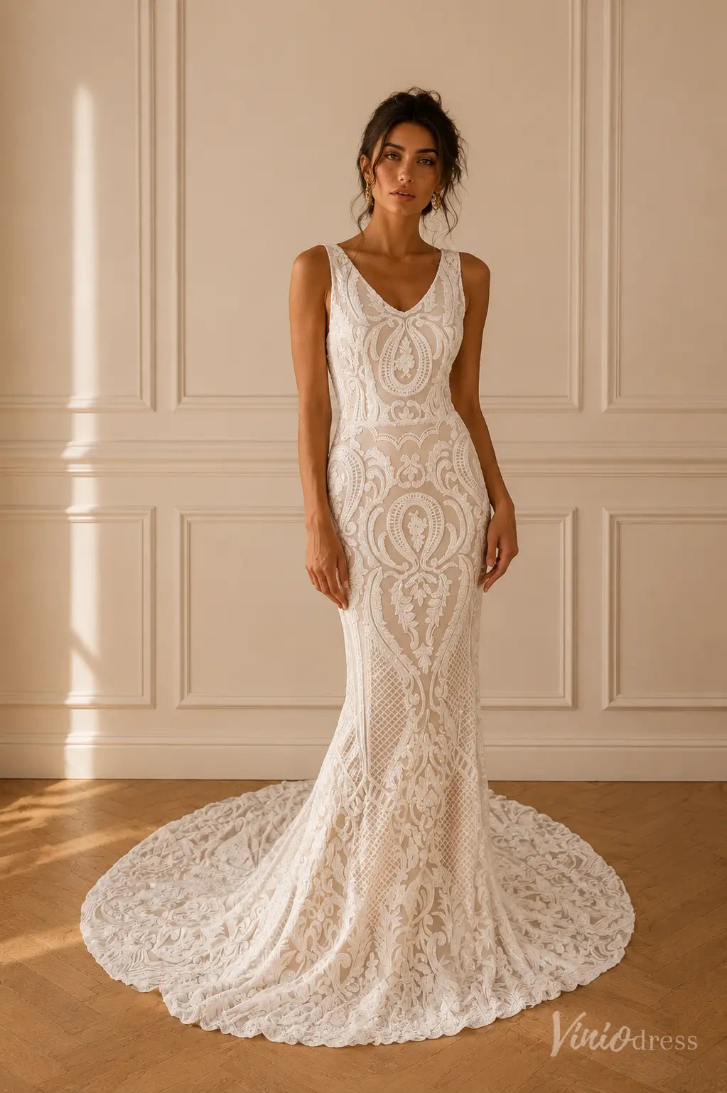 White mermaid wedding dress with ornate paisley lace, V-neckline, wide straps, and a scalloped lace train.