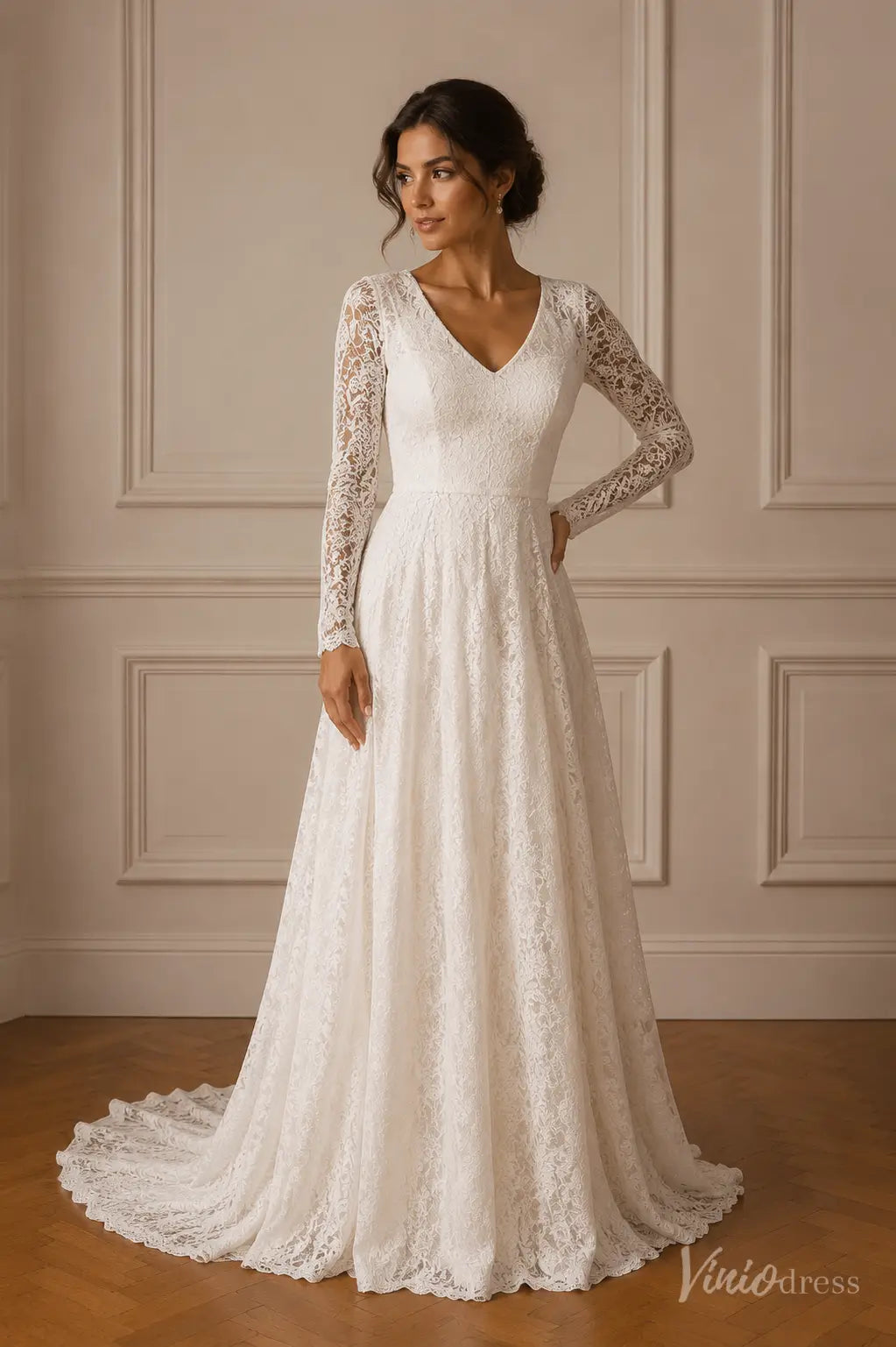 White A-line wedding dress with V-neckline, sheer long lace sleeves, and a scalloped lace train.