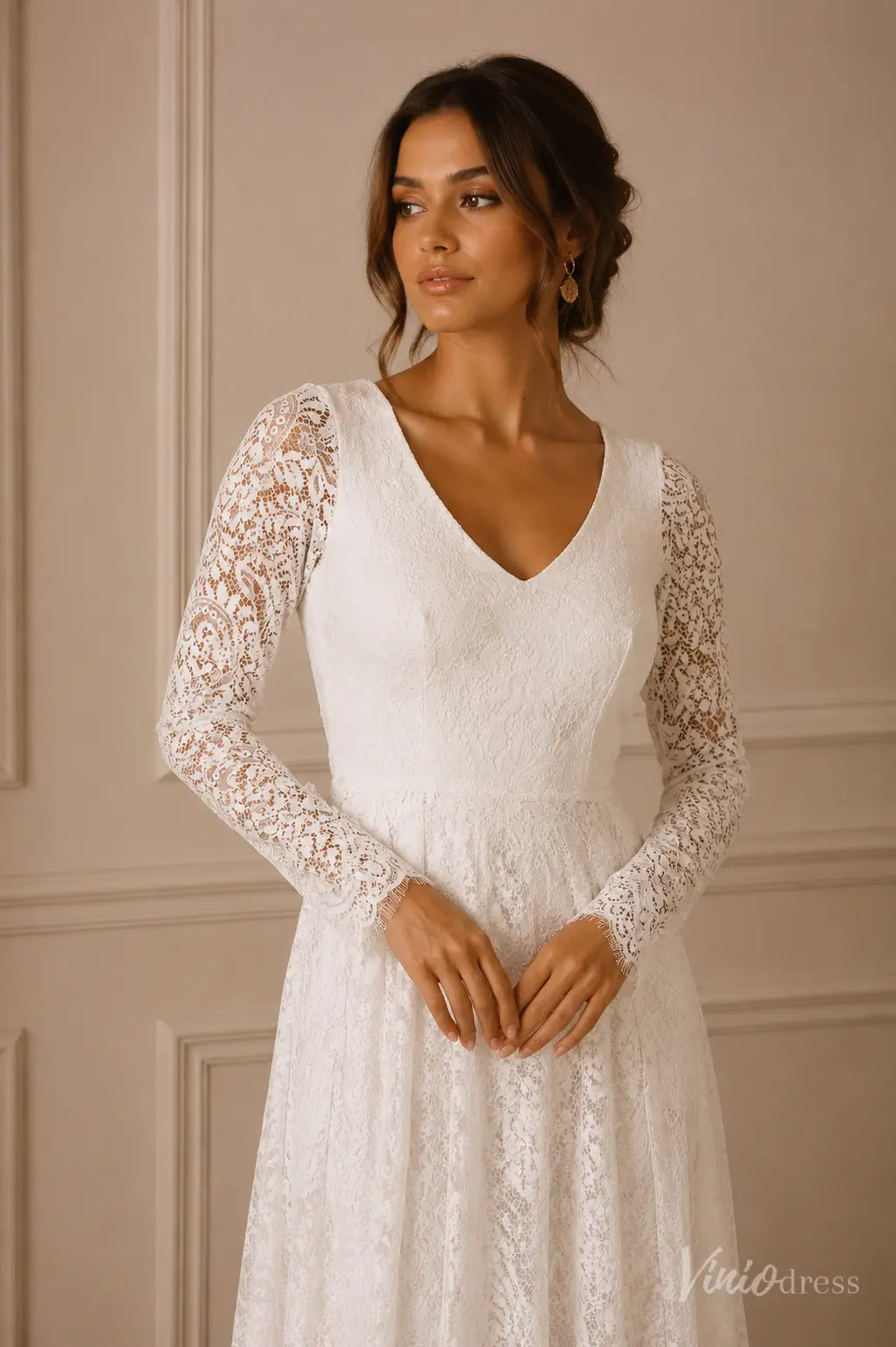 White A-line wedding dress with V-neckline, sheer long lace sleeves, and delicate eyelash lace cuffs.