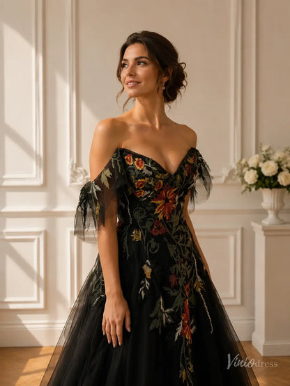 Black A-line wedding dress with vibrant meadow floral embroidery, cold shoulder sleeves, and a flattering V-neckline.
