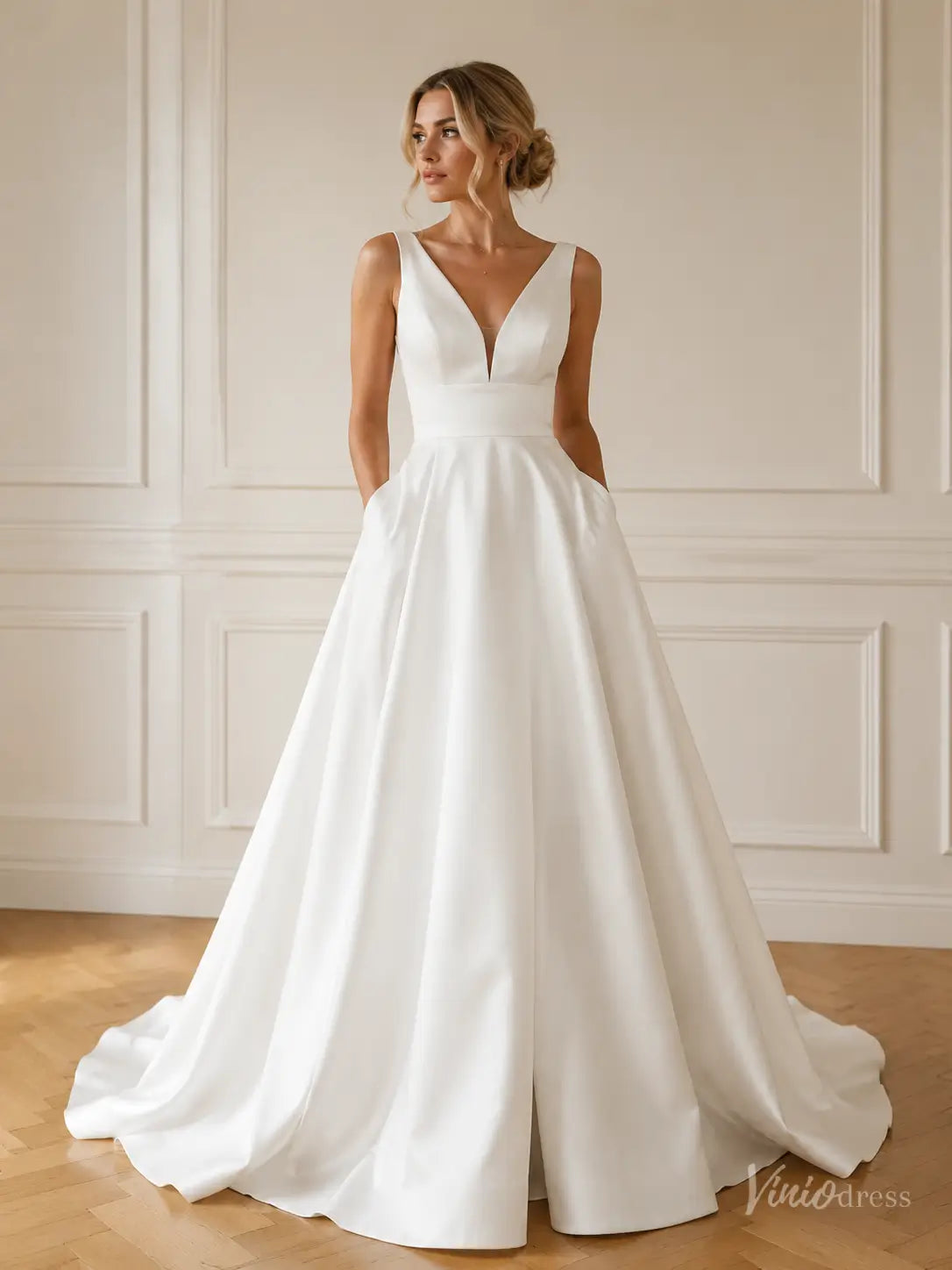 Minimalist white satin A-line wedding dress with a V-neck, structured bodice, and convenient side pockets.
