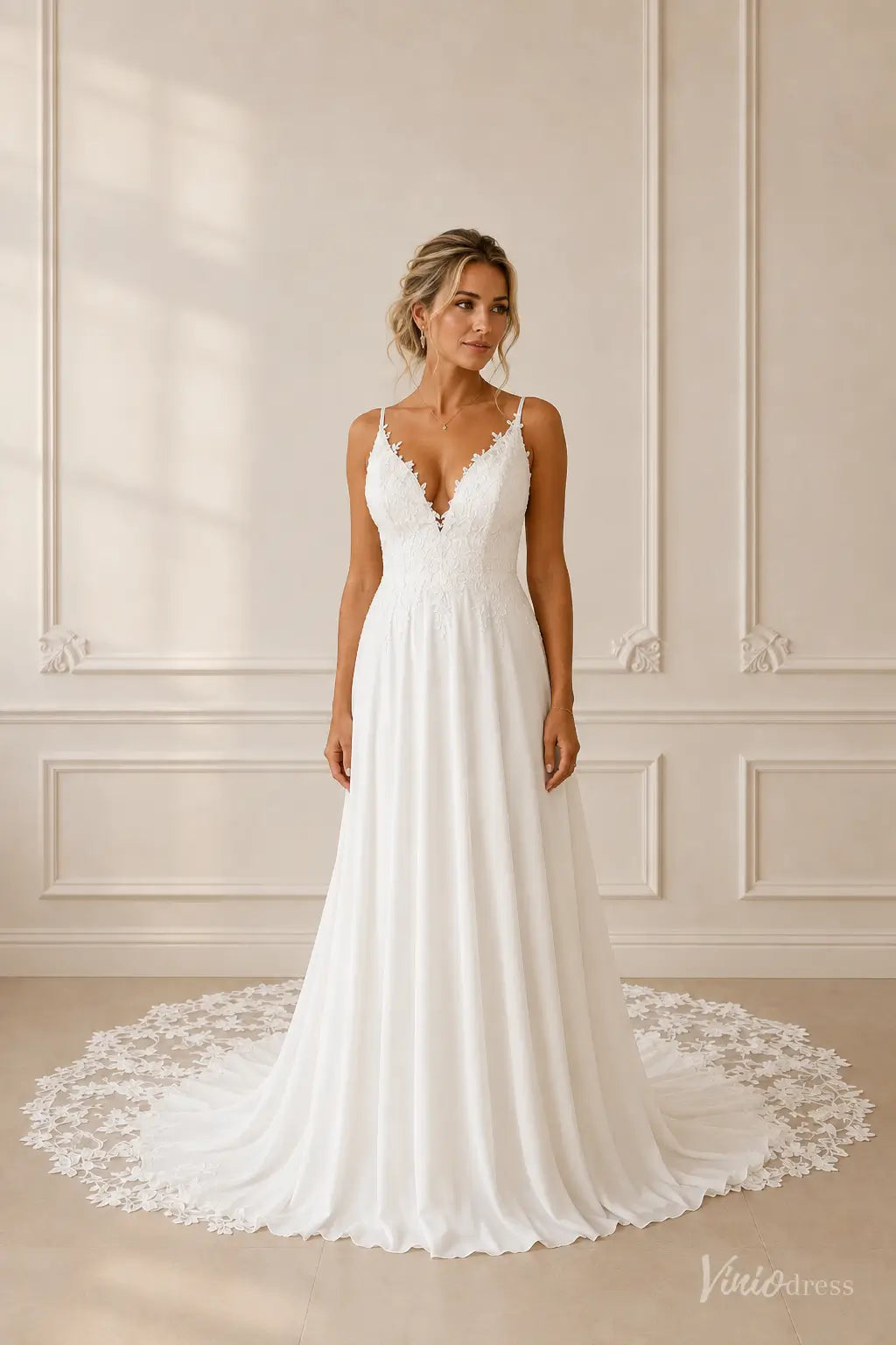 White A-line wedding dress with a V-neckline, delicate lace bodice, and a flowing chiffon skirt with a lace train.