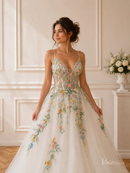 Whimsical wedding dress with spaghetti straps, floral embroidery, and a sparkling glitter tulle skirt.