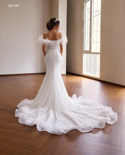 White mermaid wedding dress with feather off-shoulder trim, pearl-beaded bodice, corset back, and ruffled flared train.